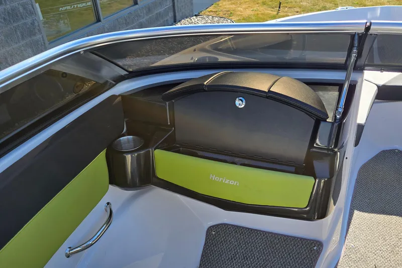 Slide: The Image of 2013 Four Winns H190RS boat interior with green accents and cup holder. - 12