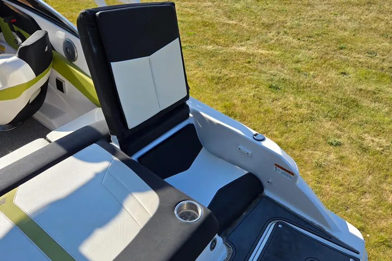 Slide: The Image of 2013 Four Winns H190RS boat interior with seating and cup holder on grassy background. - 6