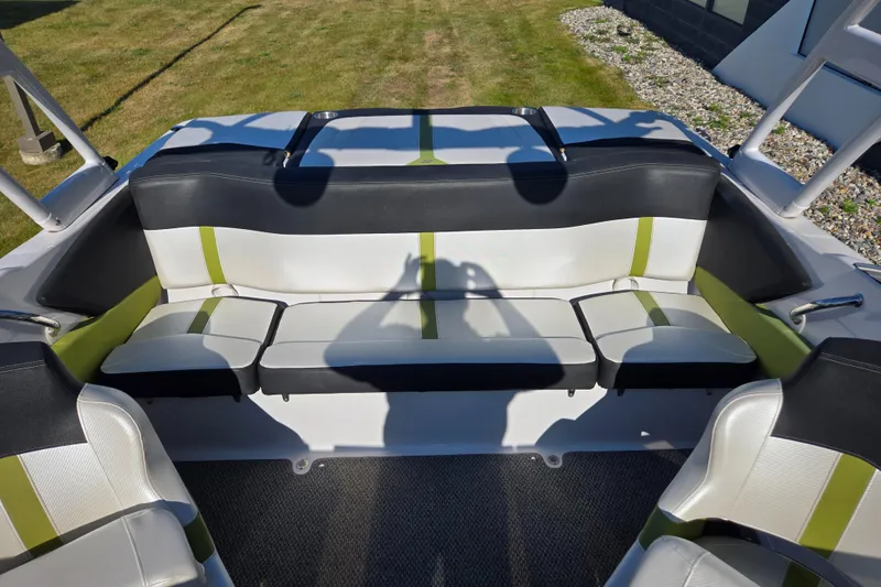 Slide: The Image of Interior of 2013 Four Winns H190RS boat with stylish seating and green accents. - 9