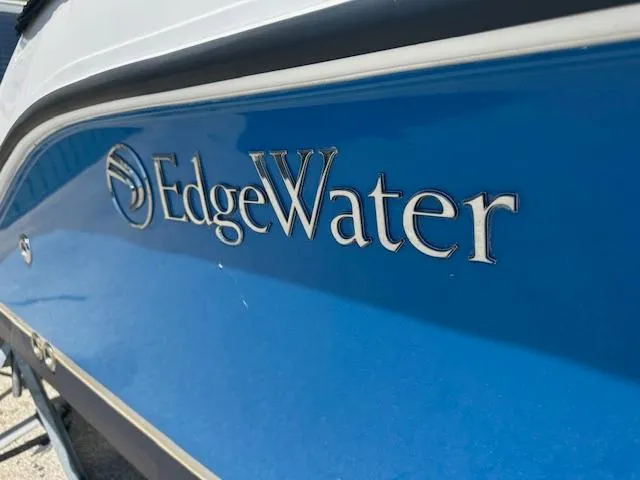 Slide: The Image of 2023 Edgewater 230CX boat interior with steering wheel, seating, and control panel. - 3