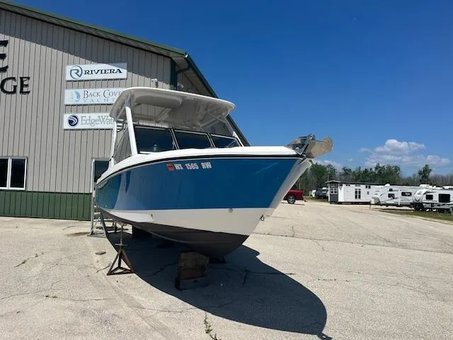 Slide: The Image of 2023 Edgewater 230CX boat with spacious white seating and modern design. - 4