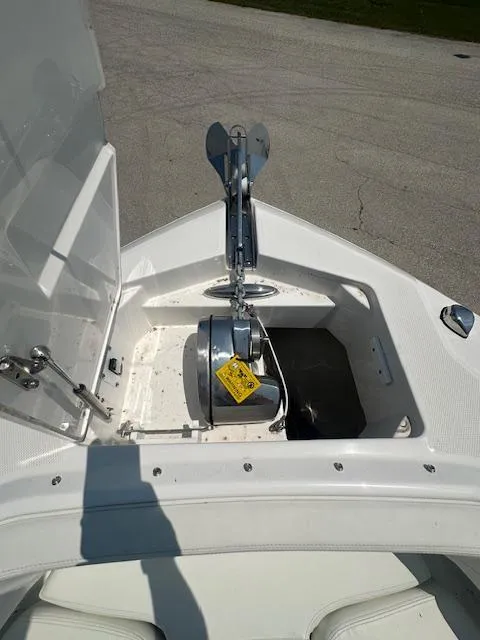 Slide: The Image of 2023 Edgewater 230CX boat with blue hull and logo detail. - 7