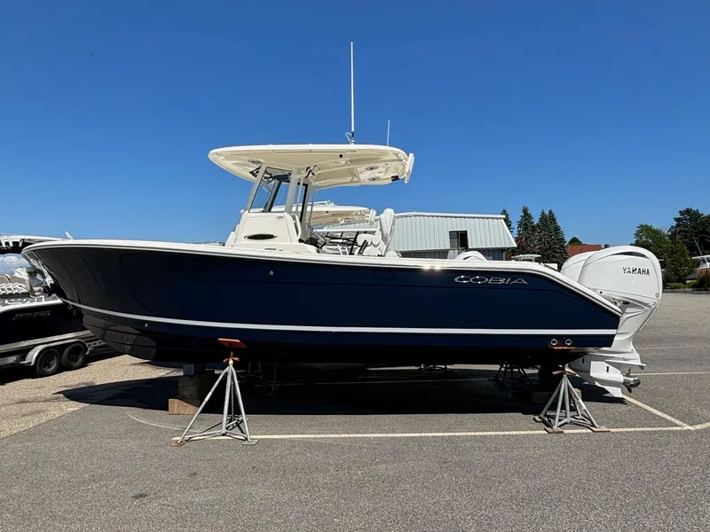 The Image of 2025 Cobia 265 Center Console boat on display in a parking lot. - 0