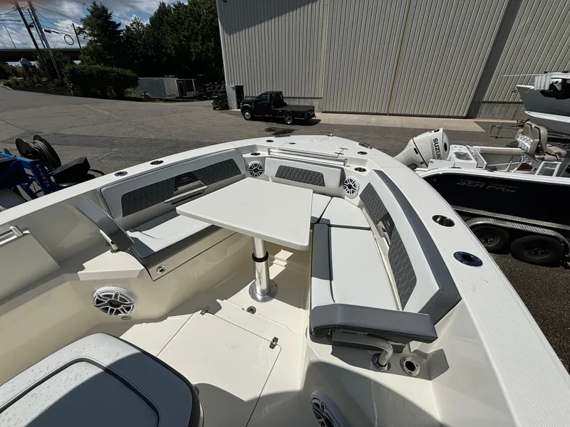 Slide: The Image of 2025 Cobia 265 Center Console boat with spacious seating and table setup. - 12
