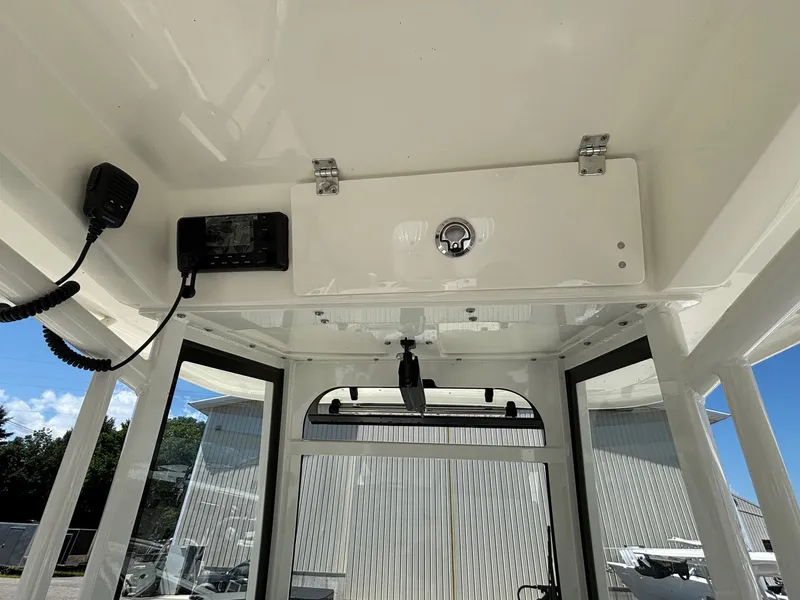 Slide: The Image of 2025 Cobia 265 Center Console boat interior with control panel and radio. - 19