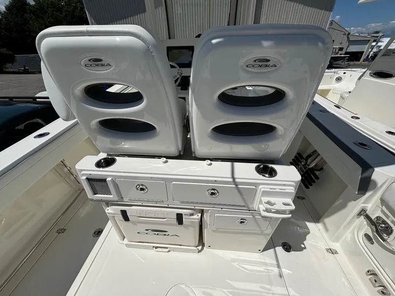 Slide: The Image of 2025 Cobia 265 Center Console boat interior with dual seats and storage compartments. - 23