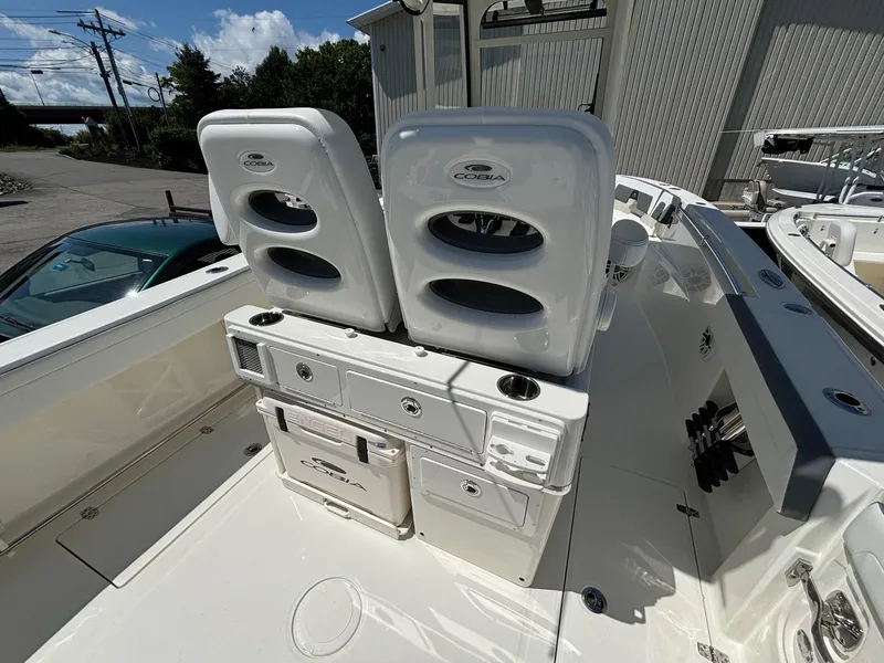 Slide: The Image of 2025 Cobia 265 Center Console boat with dual seats and storage compartments. - 25