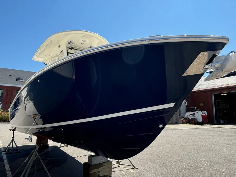 Slide: The Image of 2025 Cobia 265 Center Console boat on display outdoors. - 3