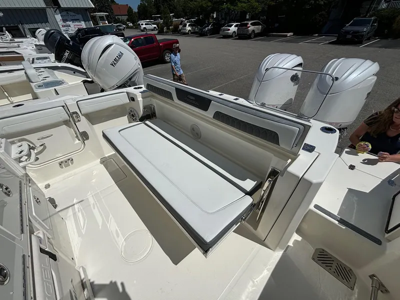 Slide: The Image of 2025 Cobia 265 Center Console boat interior with seating and Yamaha engines. - 32