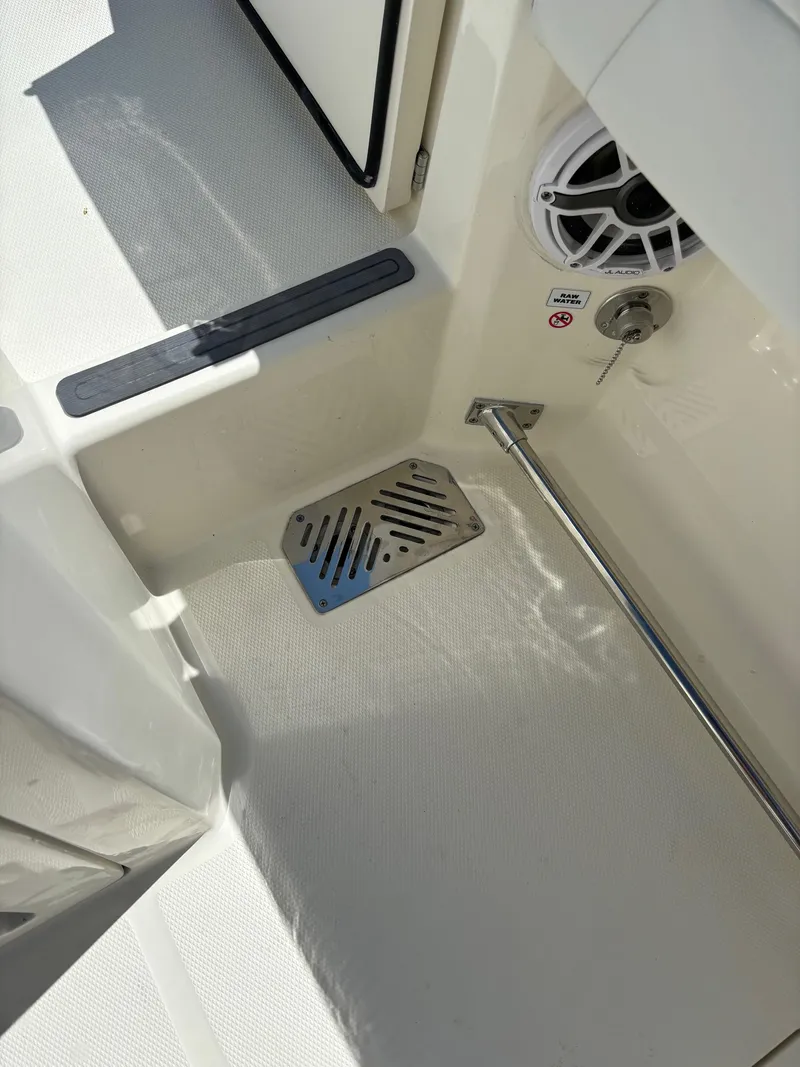 Slide: The Image of 2025 Cobia 265 Center Console boat deck with speaker and drainage system. - 35