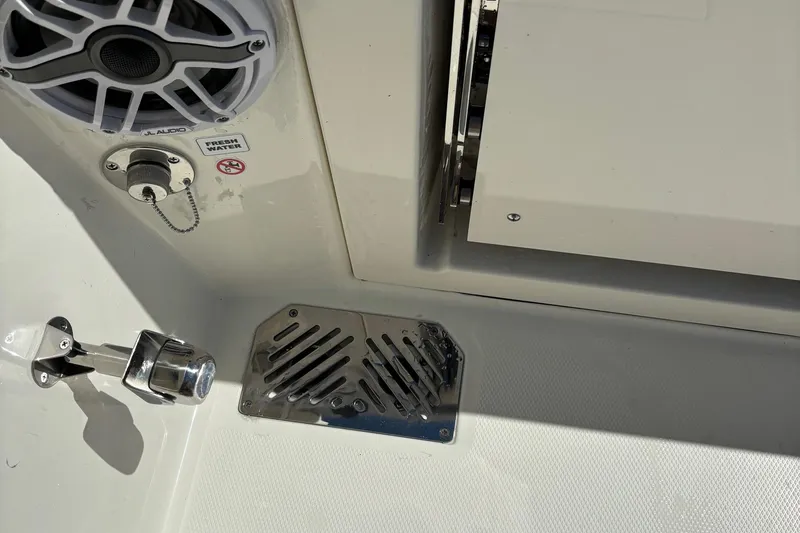 Slide: The Image of 2025 Cobia 265 Center Console boat interior with speaker and metal fixtures. - 37