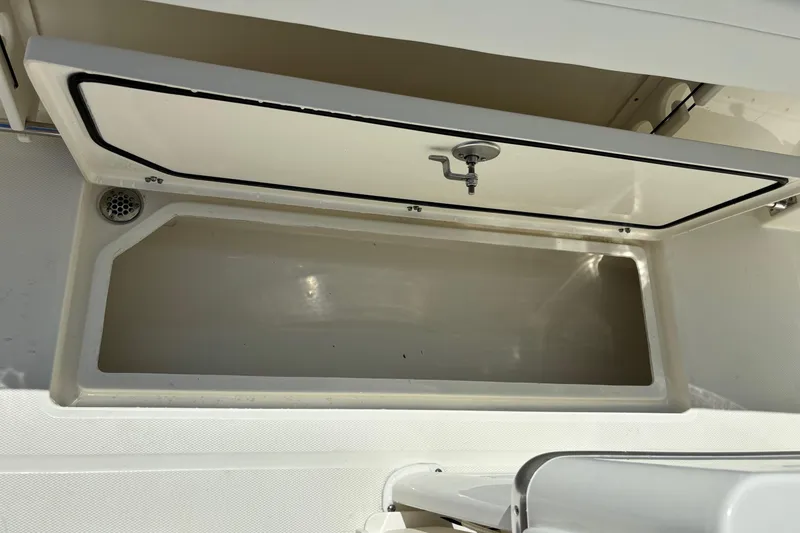 Slide: The Image of 2025 Cobia 265 Center Console storage compartment with open lid. - 38