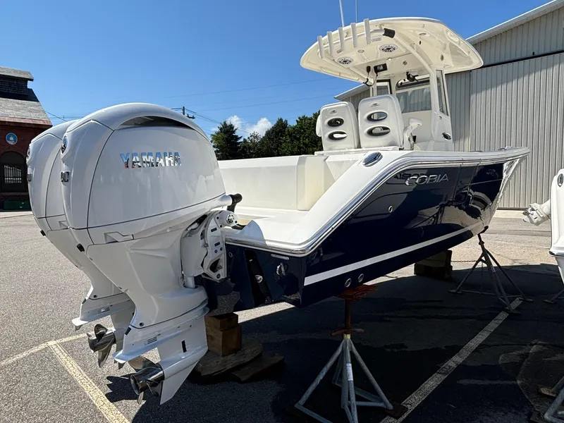 Slide: The Image of 2025 Cobia 265 Center Console boat with dual Yamaha engines, displayed outdoors. - 4