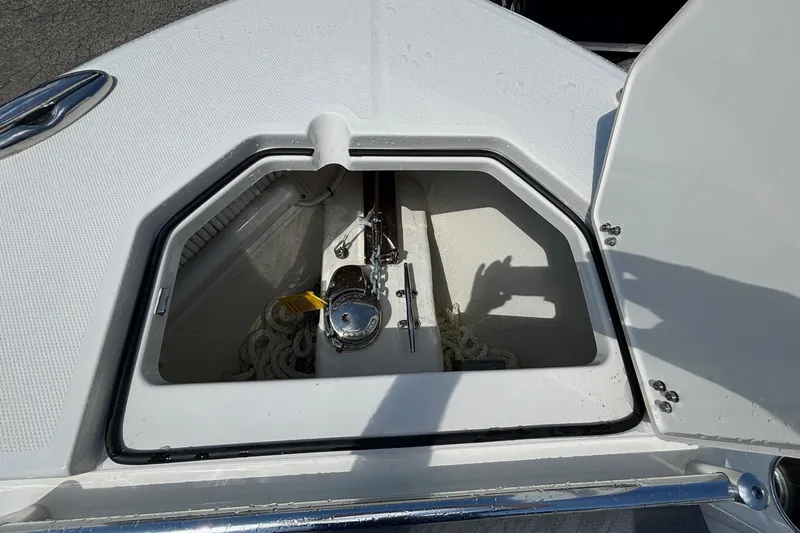 Slide: The Image of 2025 Cobia 265 Center Console anchor storage compartment, open and empty. - 6