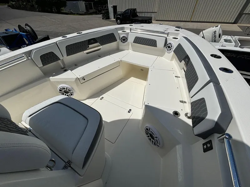 Slide: The Image of 2025 Cobia 265 Center Console boat interior with cushioned seating and speakers. - 7