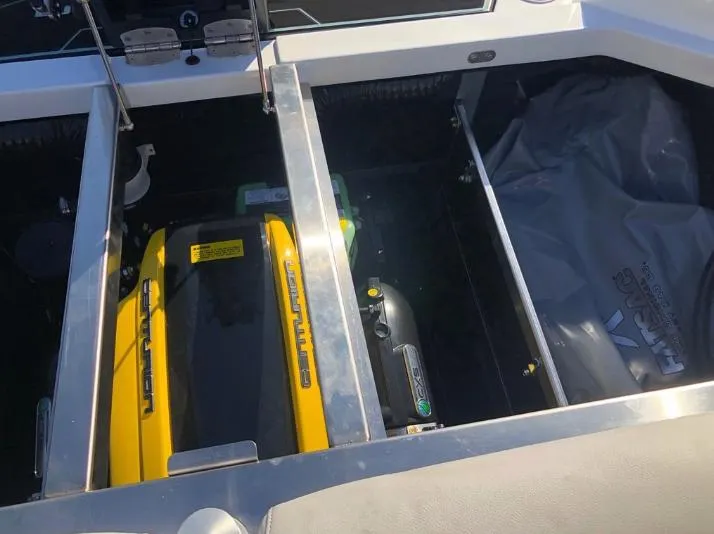 Slide: The Image of Engine compartment of a 2022 Centurion Ri 230 boat, showcasing yellow engine components. - 11