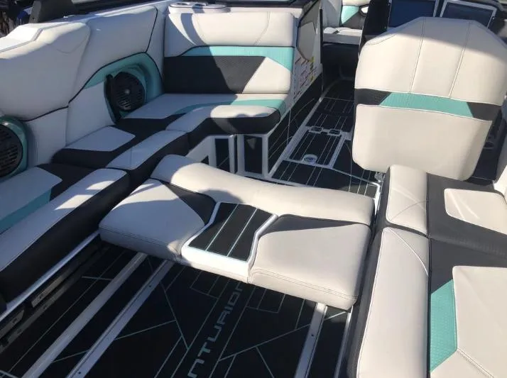 Slide: The Image of 2022 Centurion Ri 230 boat interior with stylish seating and modern design. - 14