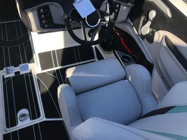 Slide: The Image of Interior of 2022 Centurion Ri 230 boat with steering wheel and seating. - 17