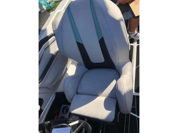 Slide: The Image of 2022 Centurion Ri 230 boat seat with gray upholstery and teal accents. - 23