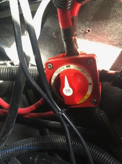 Slide: The Image of Red battery switch in a 2022 Centurion Ri 230 boat, surrounded by cables. - 26