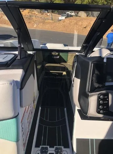 Slide: The Image of Interior view of 2022 Centurion Ri 230 boat, showcasing seating and dashboard controls. - 29