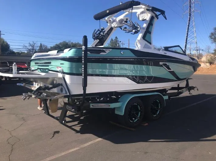 Slide: The Image of 2022 Centurion Ri 230 boat on trailer in parking lot. - 34