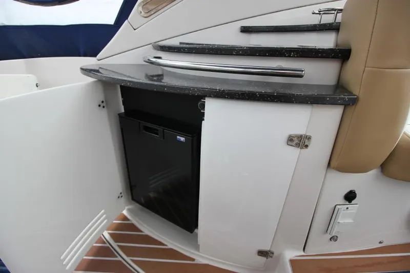 Slide: The Image of 2008 Four Winns V338 yacht interior with mini fridge and storage cabinet. - 10