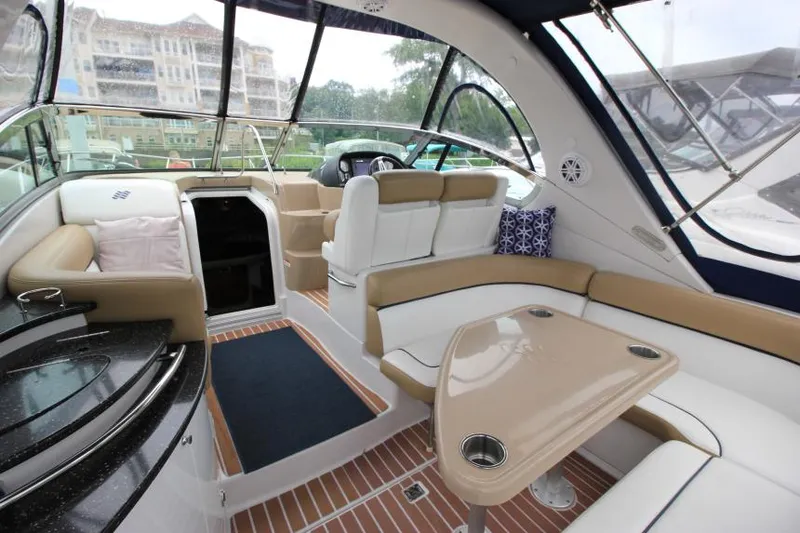 Slide: The Image of Interior of 2008 Four Winns V338 boat with seating and table, featuring modern design. - 11