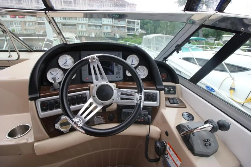 Slide: The Image of 2008 Four Winns V338 boat dashboard with steering wheel and control panel. - 15