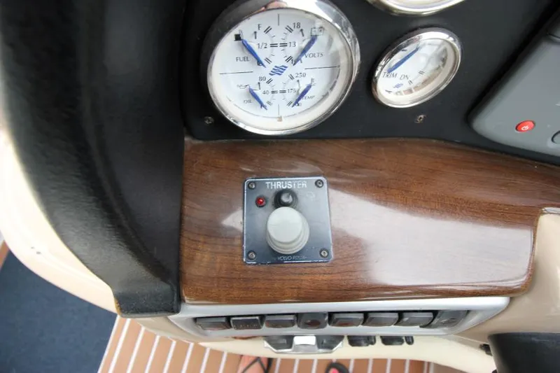 Slide: The Image of 2008 Four Winns V338 boat dashboard with gauges and thruster control. - 16