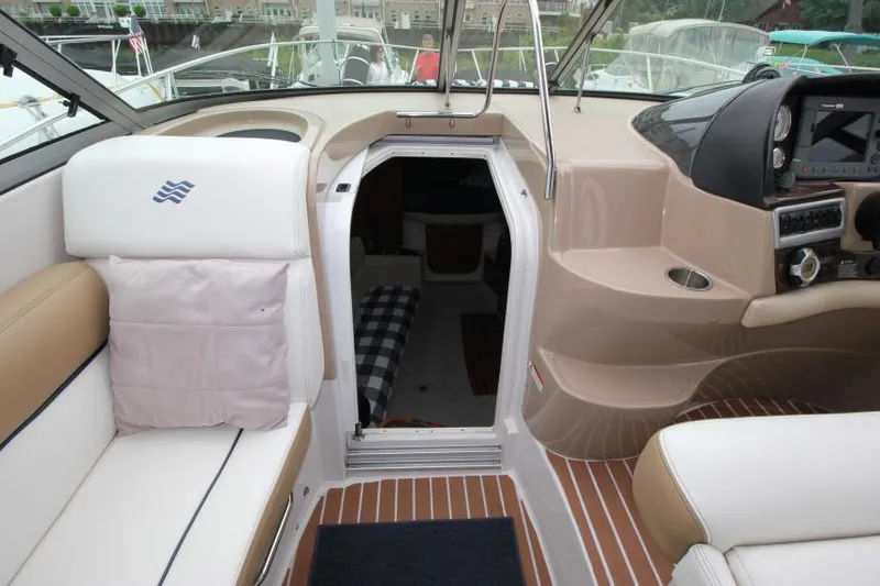 Slide: The Image of 2008 Four Winns V338 boat interior with seating, helm, and cabin entrance. - 20