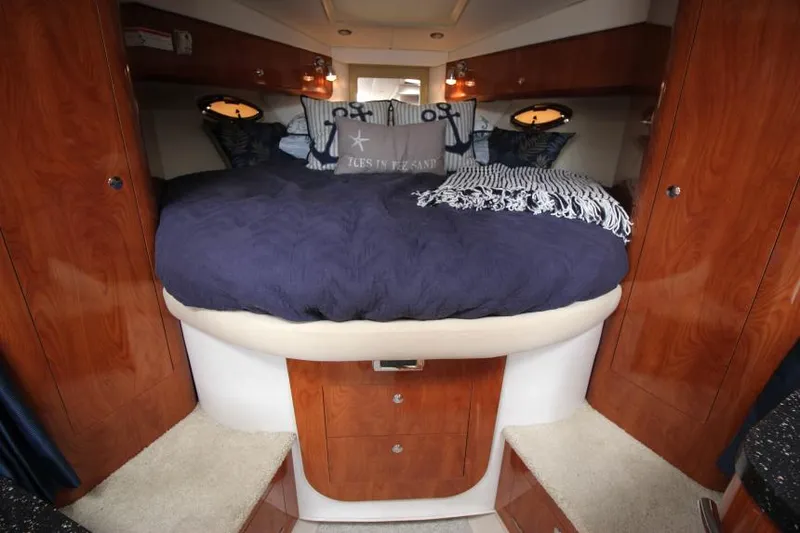Slide: The Image of Luxurious cabin interior of 2008 Four Winns V338 yacht with cozy bedding and wooden cabinetry. - 22