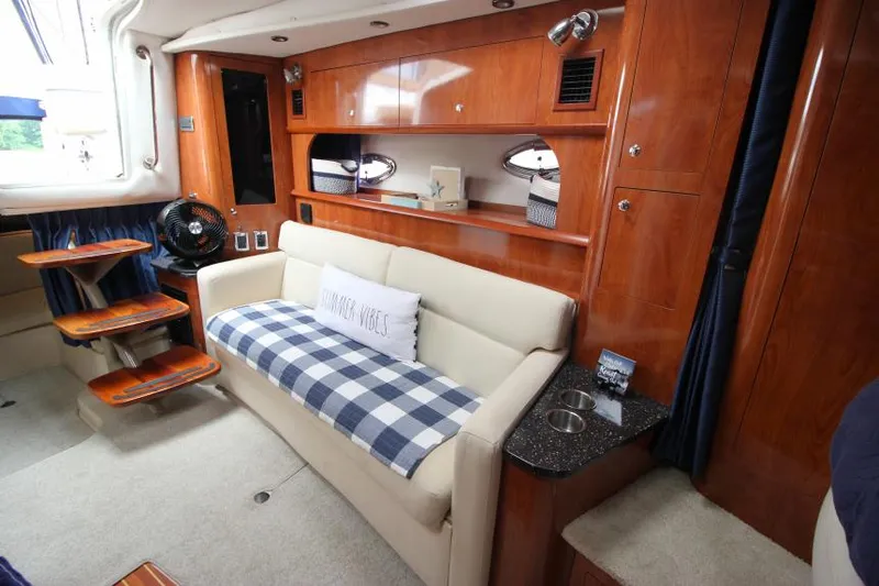 Slide: The Image of Luxurious 2008 Four Winns V338 yacht interior with cozy seating and elegant wood finishes. - 23