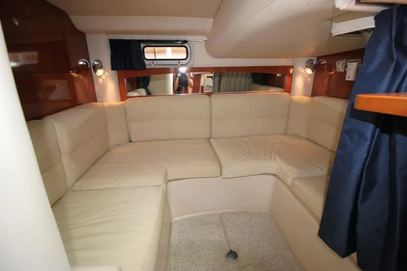 Slide: The Image of 2008 Four Winns V338 interior with beige seating and wood accents. - 28