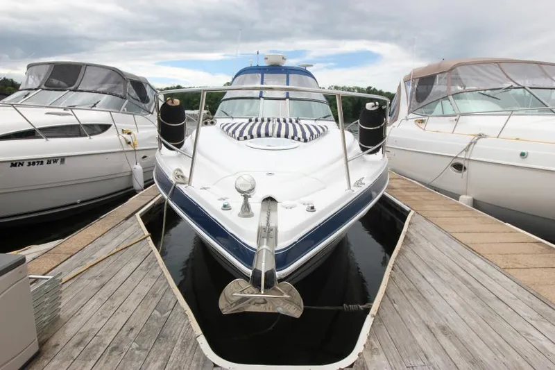 Slide: The Image of 2008 Four Winns V338 boat docked between two others on a cloudy day. - 3