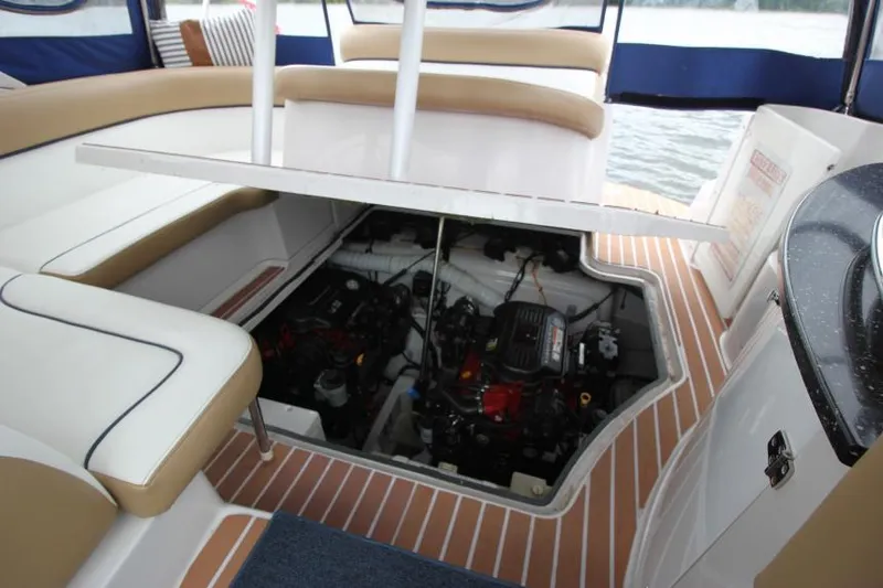 Slide: The Image of 2008 Four Winns V338 boat engine compartment with open hatch, revealing dual engines. - 30