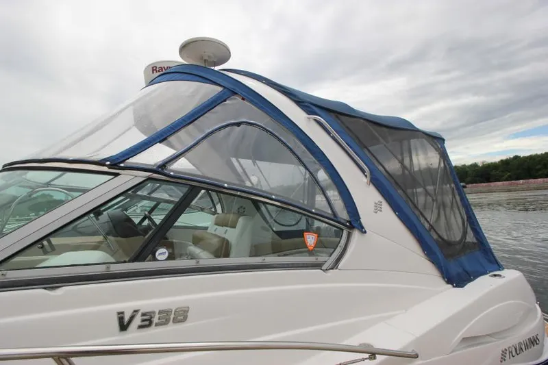 Slide: The Image of 2008 Four Winns V338 boat with blue canopy on a calm lake. - 5