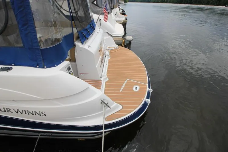 Slide: The Image of 2008 Four Winns V338 boat docked with blue canopy and wooden deck. - 6