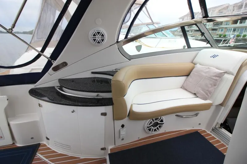 Slide: The Image of 2008 Four Winns V338 yacht interior with cushioned seating and sleek design. - 8