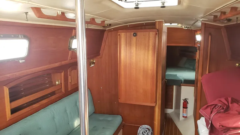 Slide: The Image of Interior of 1991 Pacific Seacraft 34 sailboat with wood finish and seating area. - 18