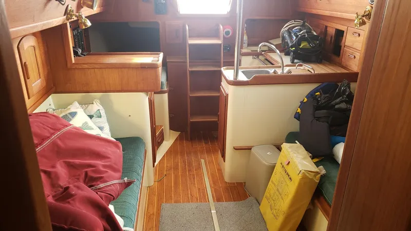 Slide: The Image of Interior of a 1991 Pacific Seacraft 34 sailboat with cozy wooden furnishings. - 20