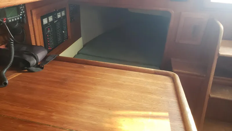 Slide: The Image of Interior of 1991 Pacific Seacraft 34 sailboat with wooden table and navigation equipment. - 22