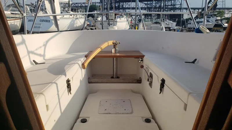 Slide: The Image of Cockpit of 1991 Pacific Seacraft 34 sailboat, featuring seating and a wooden table. - 7