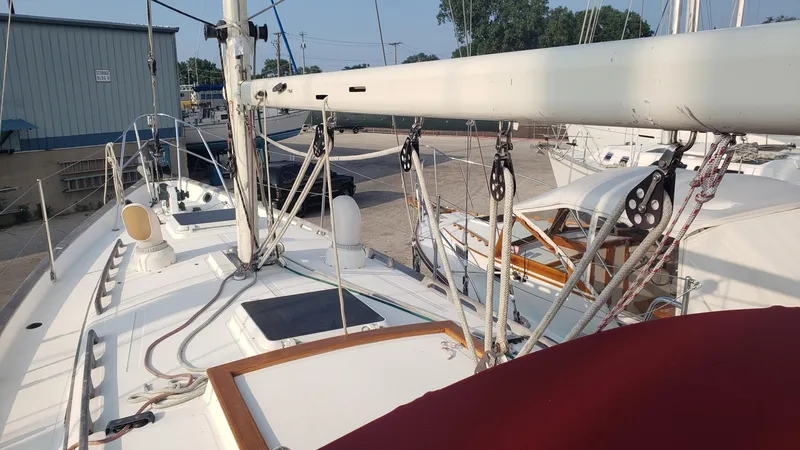 Slide: The Image of 1991 Pacific Seacraft 34 sailboat deck with rigging and equipment in a marina. - 9