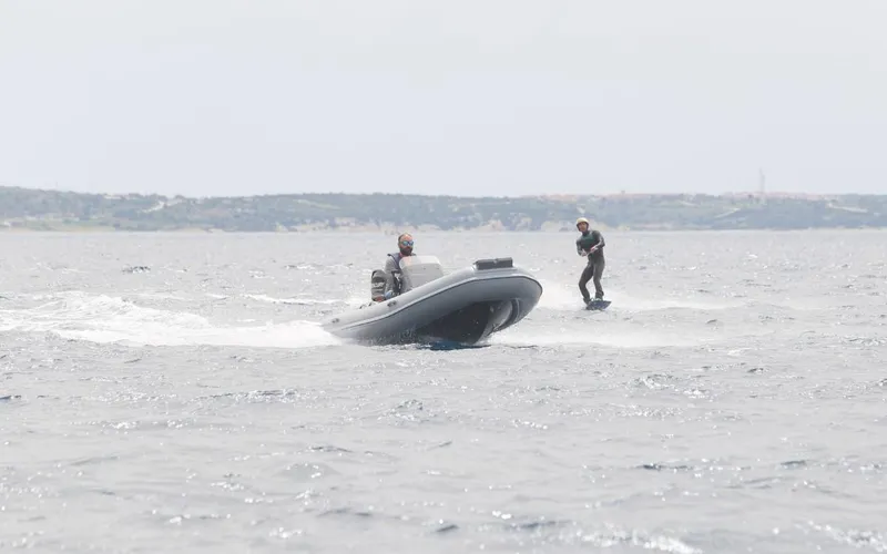 Slide: The Image of 2024 Northstar Axis 4.2 boat towing a wakeboarder on open water. - 5