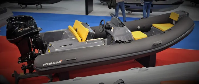 Slide: The Image of 2024 Northstar Axis 4.2 inflatable boat with Tohatsu outboard motor on display. - 7