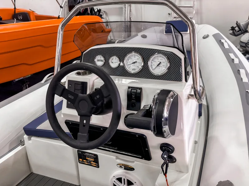 Slide: The Image of 2023 Northstar Axis 4.2 boat dashboard with steering wheel and gauges. - 3