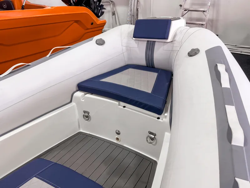 Slide: The Image of 2023 Northstar Axis 4.2 inflatable boat interior with blue and white seating. - 5