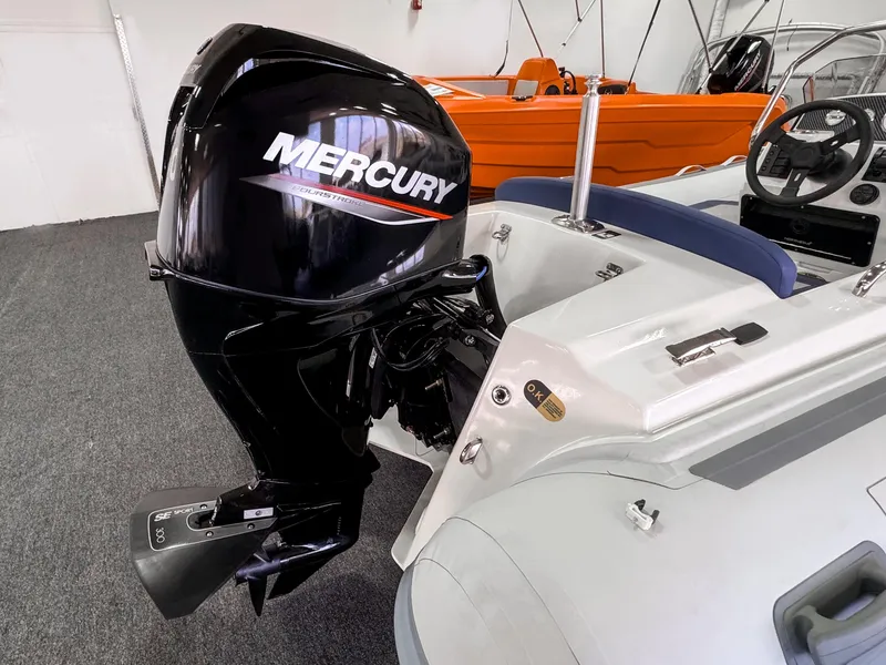 Slide: The Image of 2023 Northstar Axis 4.2 boat with Mercury outboard motor in showroom. - 6