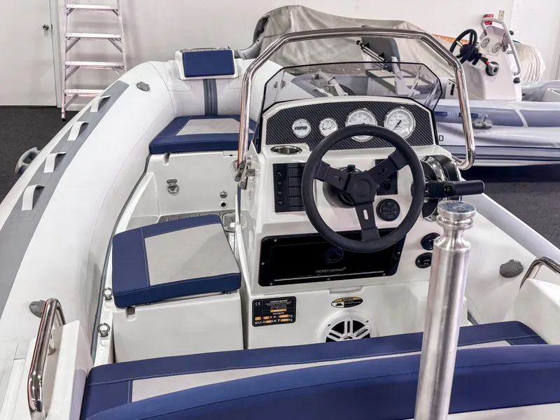 Slide: The Image of 2023 Northstar Axis 4.2 boat interior with steering wheel and seating. - 8